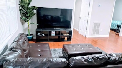 Living area with wood finished floors and baseboards