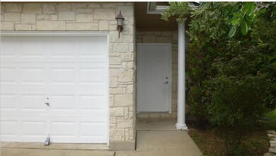 Entrance to property with a garage and stone sidi