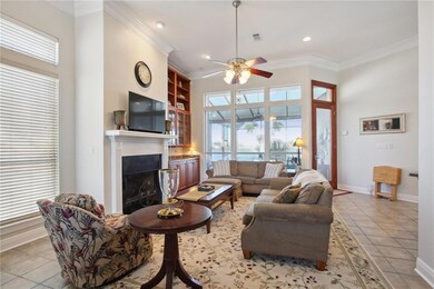 Living room, note beautiful view of pool and water