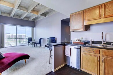 View from the kitchen into the living room. Since the condo is situated on the southeast corner of the property, you re guaranteed to have an abundance of natural light throughout the home.