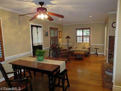 Dining Room. Wood Floors, Plantation Shutters, Fireplace, Dutch Door that leads to brick patio.