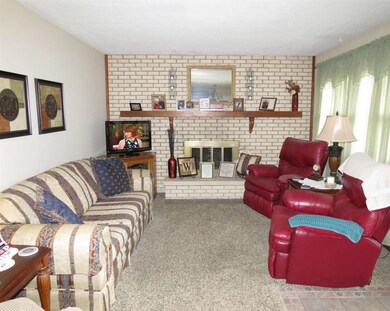 Living room area with wood burning fireplace