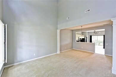 Open 2 story Living room opens to dining area