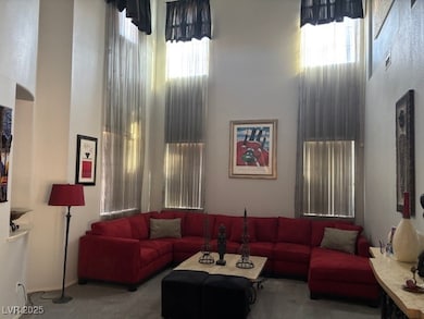 Living area with carpet flooring and a towering ce