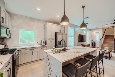 Kitchen with tasteful backsplash, recessed lighti