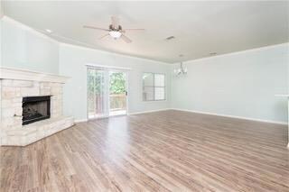 Unfurnished living room with ornamental molding, 