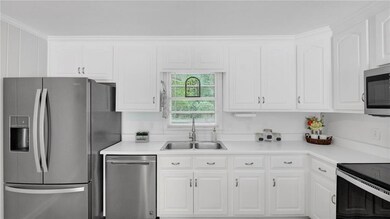 Kitchen featuring a sink, stainless steel applianc
