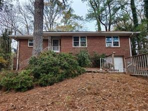View of front facade with brick siding and an attached garage