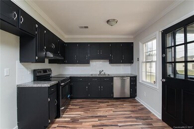 This beautiful kitchen features newly repainted ca