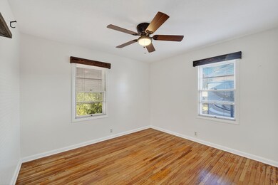 Empty room featuring hardwood / wood-style floors and ceiling fan
