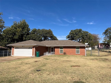 Single story home with a garage and a front yard