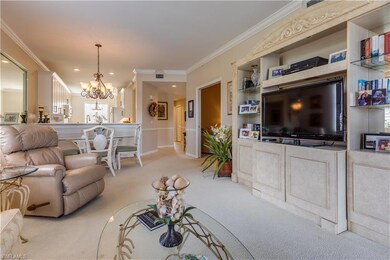 Living room featuring crown molding, light colored