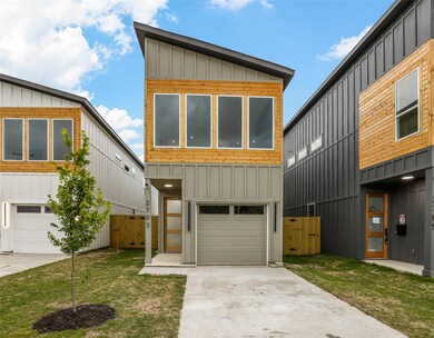 Contemporary house with a garage and a front yard