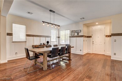 Dining area featuring a decorative wall, dark wood