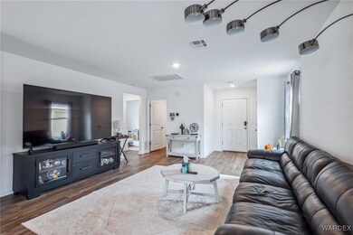 Living room with baseboards, visible vents, and da