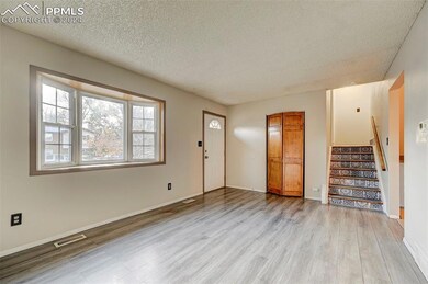 Entrance foyer with a textured ceiling and light h