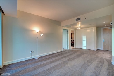 Living room with carpet flooring, baseboards.