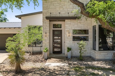 View of exterior entry featuring stone siding, st