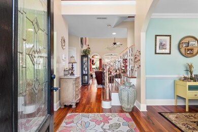 Foyer entrance featuring ornamental molding, dark 