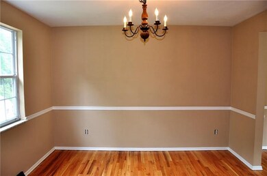 Dining room has refinished hardwood floors and fre