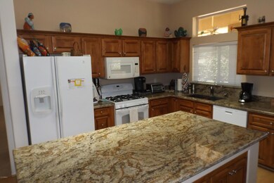 KITCHEN UP-DATES INCLUDE GRANITE COUNTER TOPS & REFINISHED CABINETS.