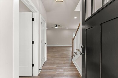 Entryway featuring stairway, light wood-style flooring, a ceiling fan, and recessed lighting