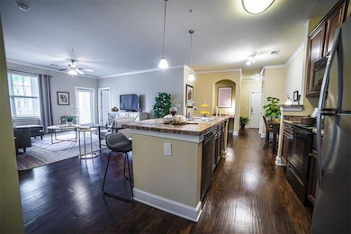 Kitchen featuring black appliances, a center islan
