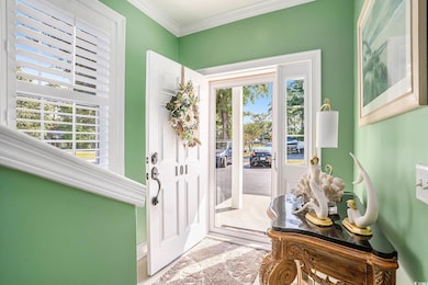 Entrance foyer featuring crown molding