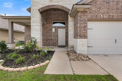 Entrance to property featuring brick siding, an at