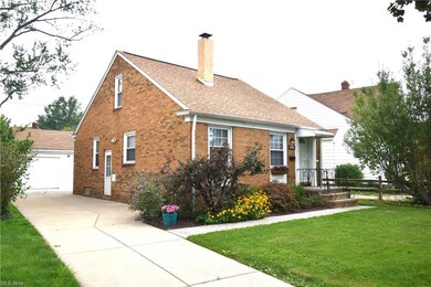 View of property exterior featuring a wide concrete driveway and garage