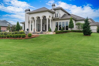 Back of house with a yard, pool and outdoor living