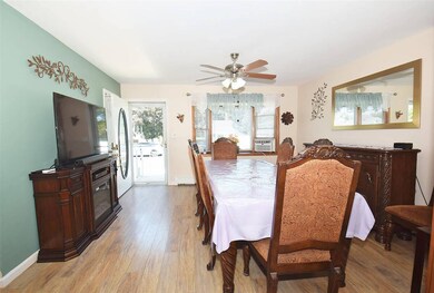 Dining room featuring light wood-style flooring, a ceiling fan, and cooling unit