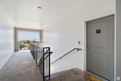 View of exterior entry with a balcony