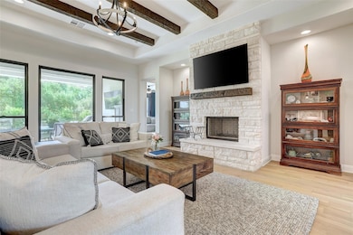 Living room with beam ceiling, wood finished floo