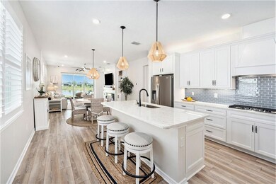 Fantastic kitchen with pantry, large island, stainless steel upgraded Whirlpool appliances, soft blue subway tile backsplash, upper and lower cabinet lighting and so much more!