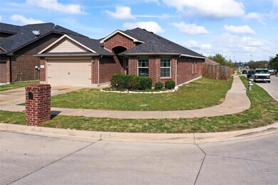 Ranch-style house with fence, a garage, brick sidi