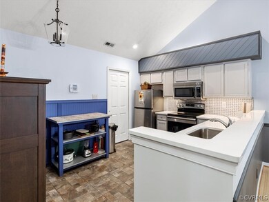 Quartz counter-tops, marble backsplash, tiled floor.