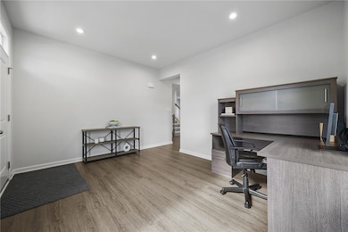 Enter through the covered porch into a flex room, which could easily serve as a living room or home office.