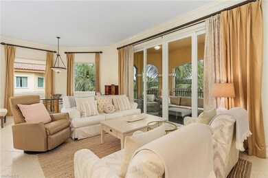 Living room with ornamental molding and light tile