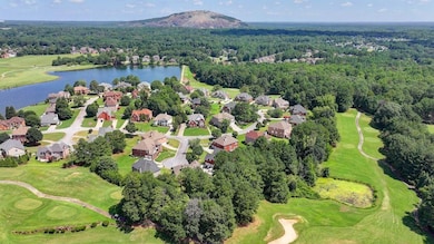 Aerial view of residential area featuring a water and mountain view and a local golf course