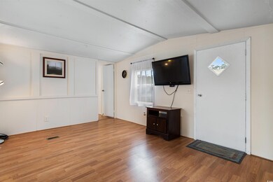 Entryway featuring vaulted ceiling with beams and 