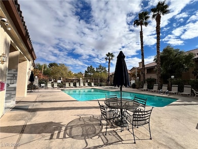 Community pool featuring fence and a patio area