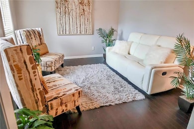 Sitting room with wood finished floors and baseboards