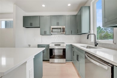 Kitchen with stainless steel appliances, a sink, 