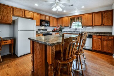 Spacious and designed for convenience the kitchen boasts a beautiful custom-made island with seating space, as well as an organizing desk.
