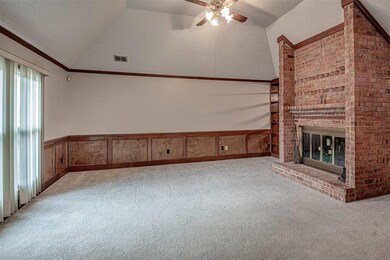 Main living space with feature brick fireplace.