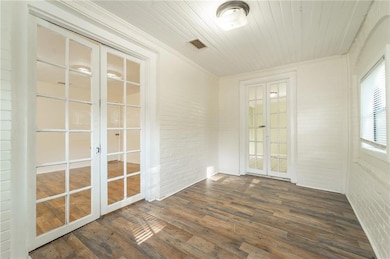 Unfurnished sunroom with french doors