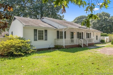 Single story home featuring a front lawn and a por