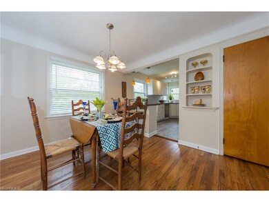 The dining room with hardwood floor and display sh