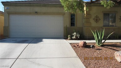 View of front facade with concrete driveway, a gar